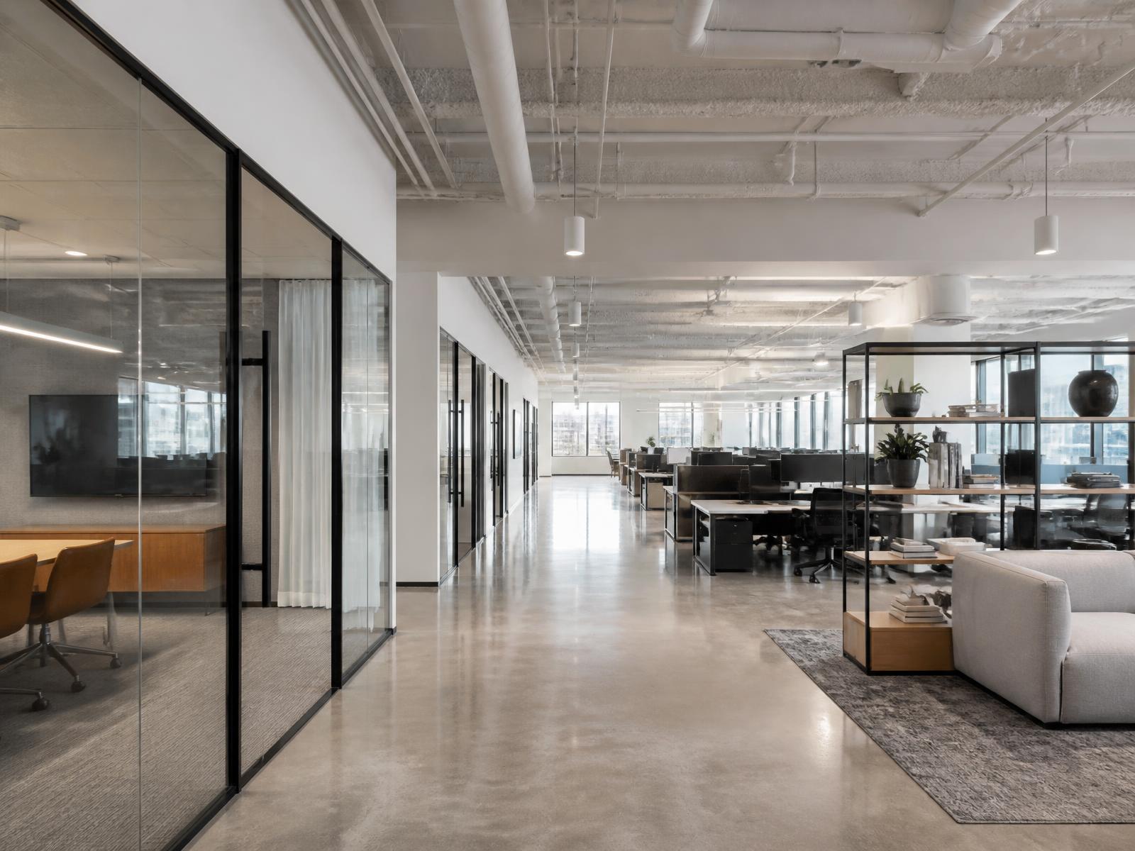 Completed commercial office tenant improvement with glass partitions, polished concrete floors and open workstations